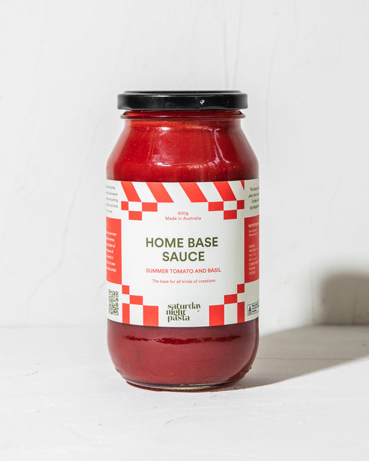 Jar of 'Home Base Sauce' with a red label on a white background