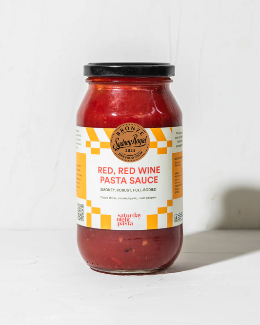 Jar of red wine pasta sauce with a label on a white background
